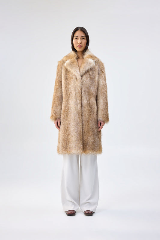 Person wearing a faux fur coat on a white background